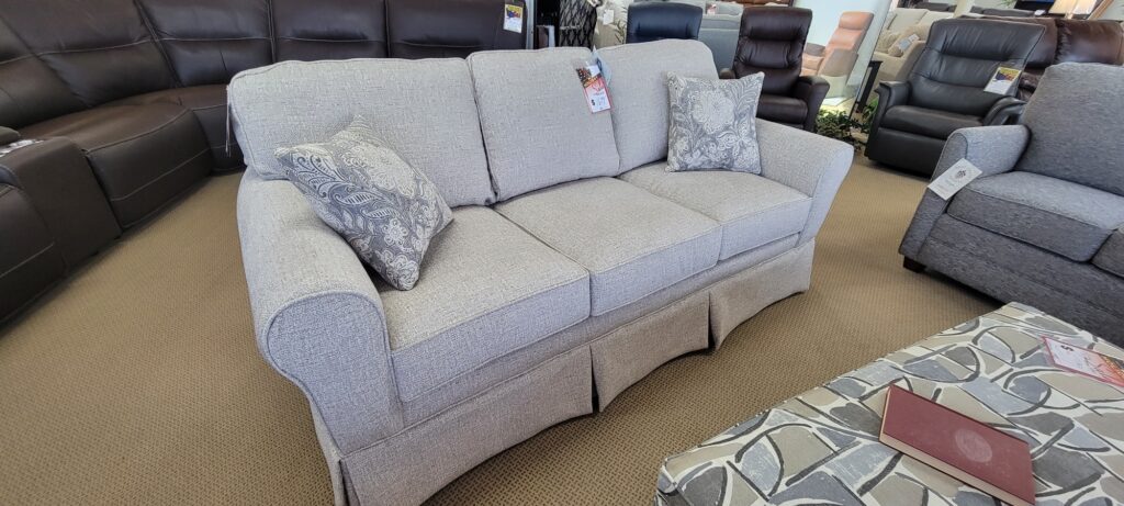 Light gray fabric sofa with accent pillows on the showroom floor at Meyers Furniture in Rochelle IL

