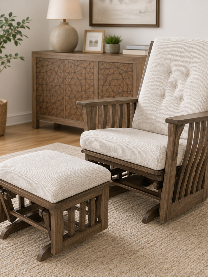 Wood reclining lounge chair with matching ottoman and cream upholstered cushions in a warm neutral living room setting