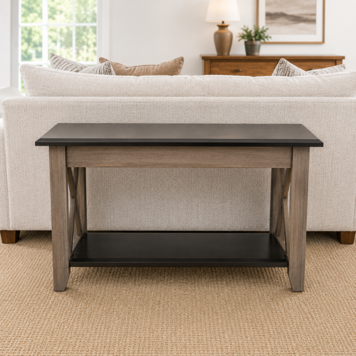 Rustic two-tone sofa table with lower shelf and X-frame side accents placed behind a light-colored sofa