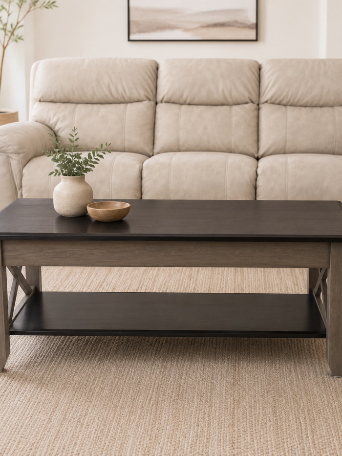 Rustic two-tone rectangular coffee table with lower storage shelf and X-frame side accents on a white background