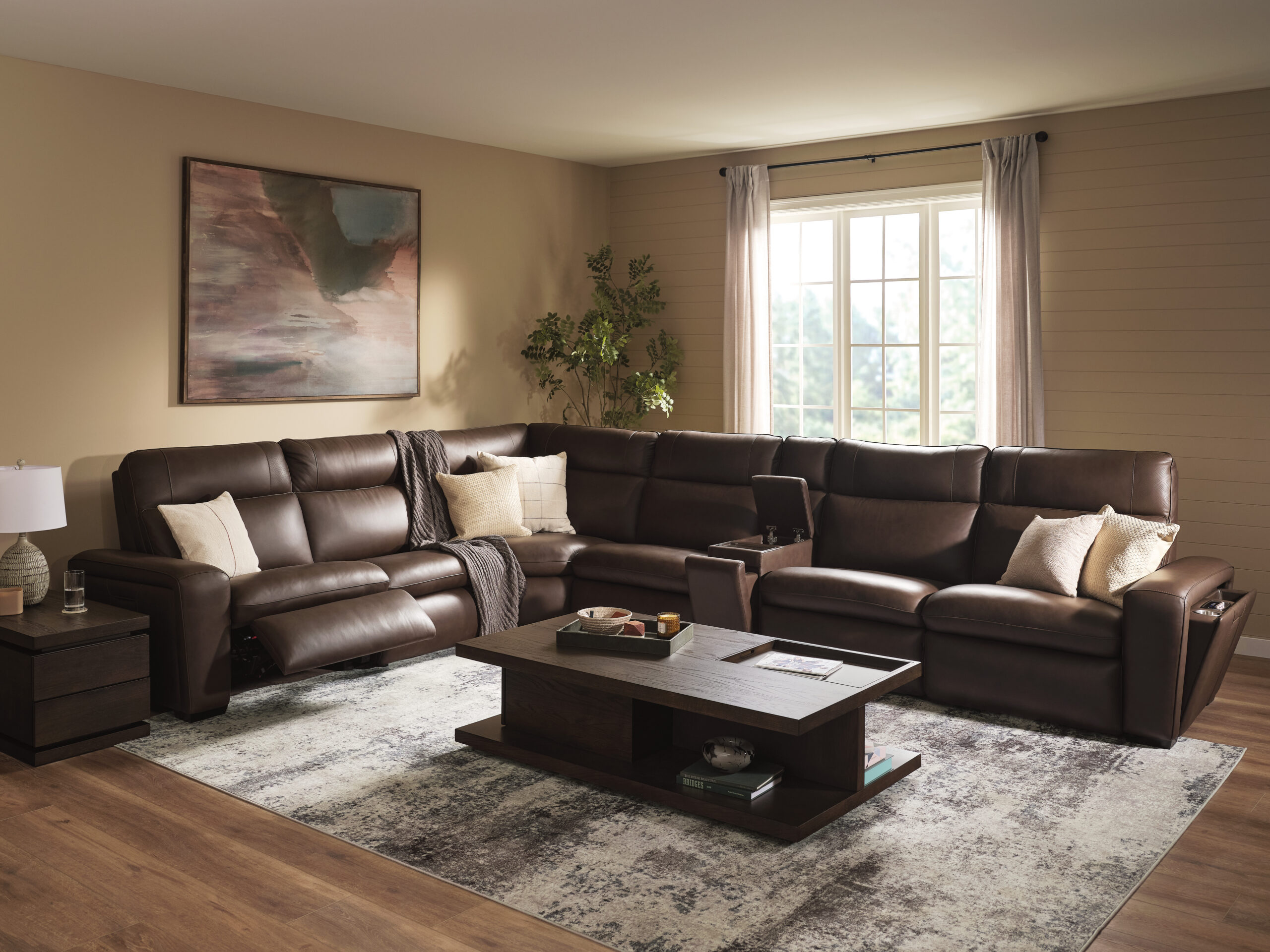 Flexsteel Pulse power reclining sectional in dark brown upholstery arranged in a living room with pillows, coffee table, and area rug.