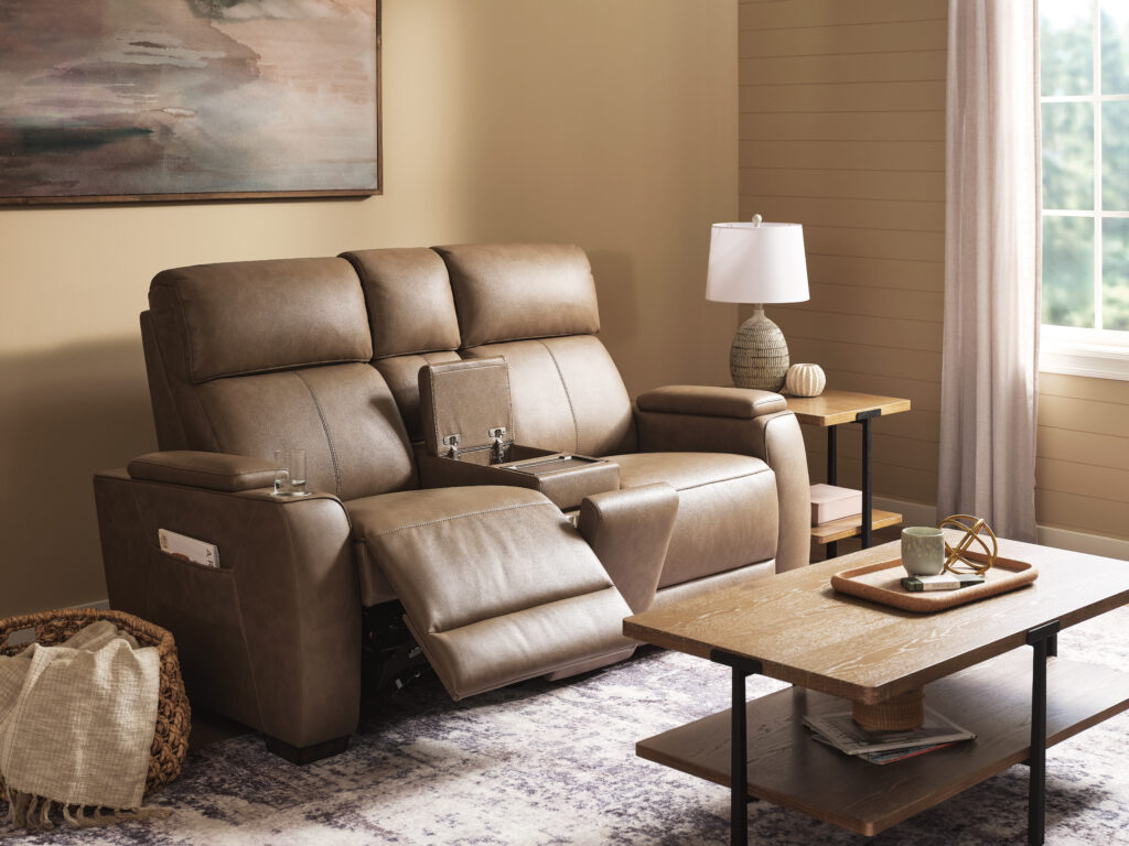 Flexsteel Pulse power reclining loveseat with open center console, cupholders, and warm brown upholstery in a living room setting.