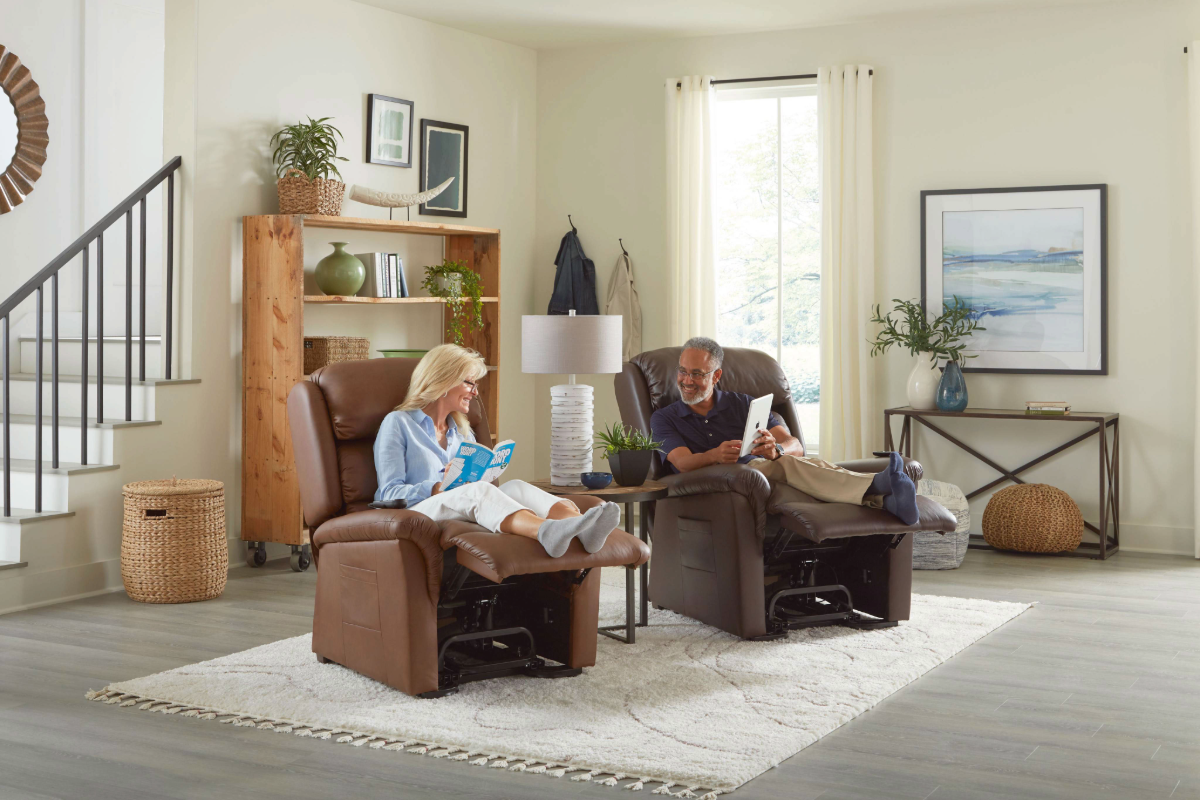 Couple relaxing in power recliners in a bright living room