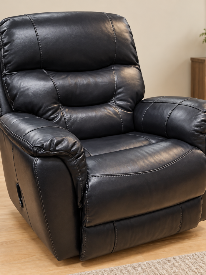 HomeStretch black recliner with a segmented pillow back, plush arms and light contrast stitching