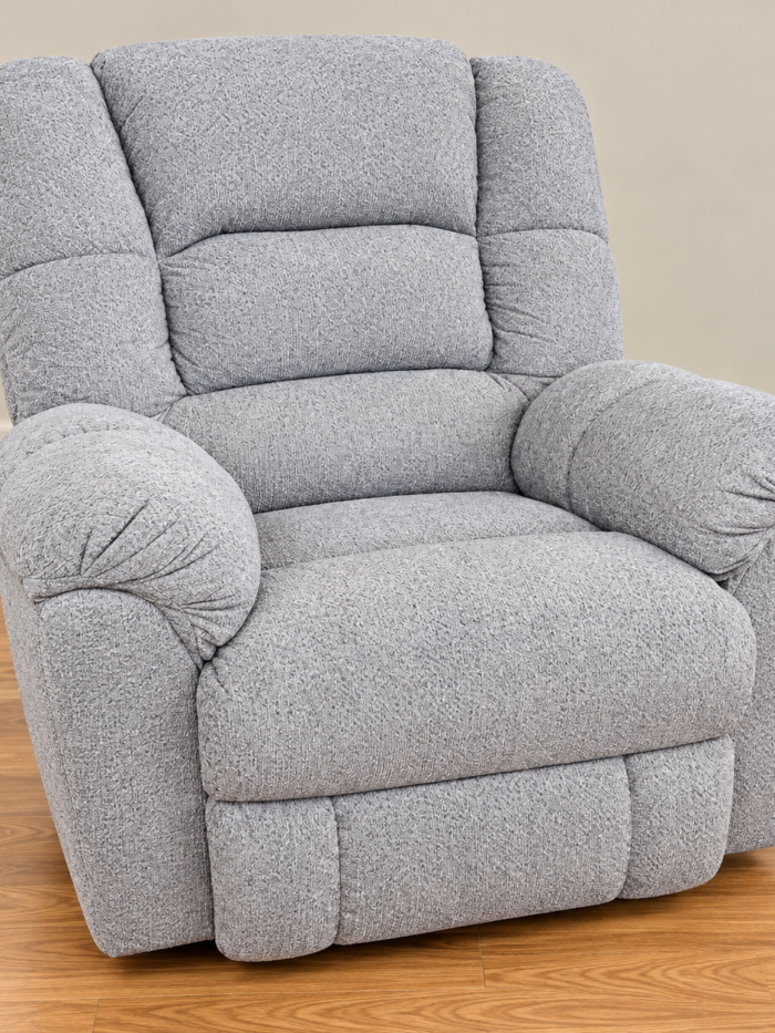 HomeStretch light gray plush recliner with tiered back cushions and generously rounded arms