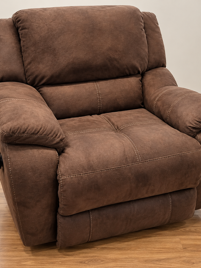 HomeStretch warm brown recliner with pillow-top arms, a broad cushioned back and contrast stitching