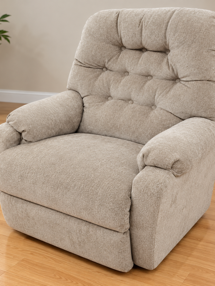 Best Home Furnishings beige recliner with a button-tufted back and rounded padded arms