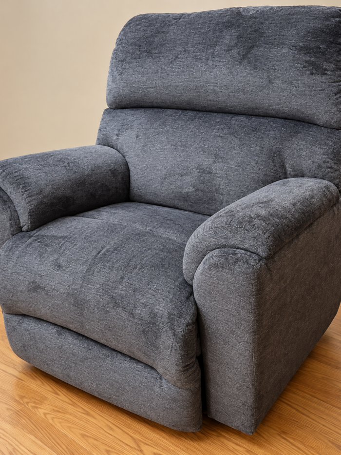 Best Home Furnishings charcoal gray recliner with a broad split back and rounded padded arms