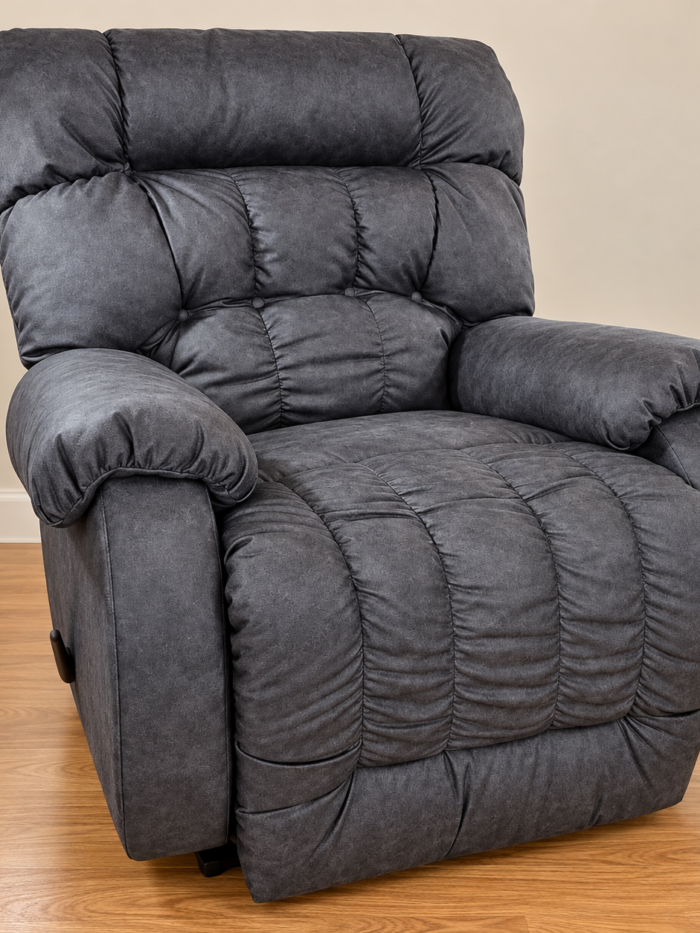 Best Home Furnishings charcoal recliner with an overstuffed tufted back and pillow arms