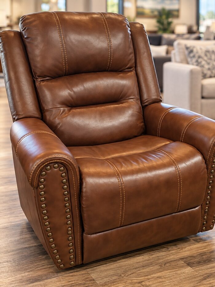 Flexsteel cognac recliner with rolled arms, nailhead trim, and contrasting stitching